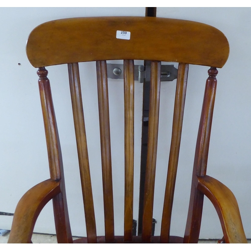 259 - A late Victorian lath back chair, raised on turned legs