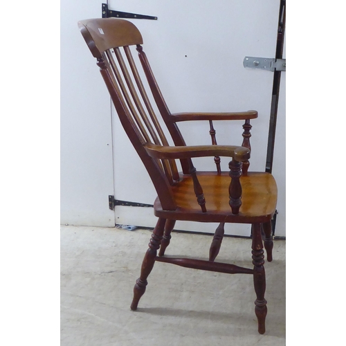 259 - A late Victorian lath back chair, raised on turned legs