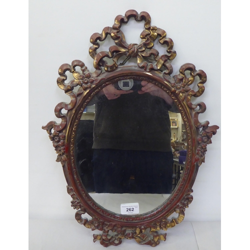 262 - A 20thC Victorian style mirror, the oval plate set in a ribbon moulded gilt frame  19