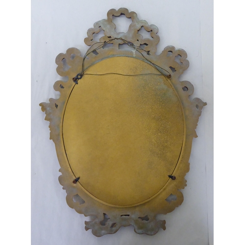 262 - A 20thC Victorian style mirror, the oval plate set in a ribbon moulded gilt frame  19