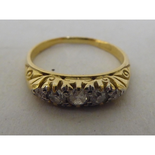 263 - An 18ct gold ring, set with five graduated diamonds