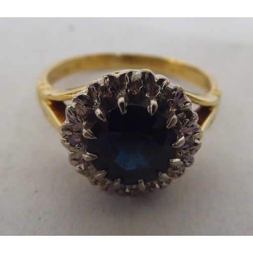 265 - An 18ct bi-coloured gold sapphire and diamond cluster ring