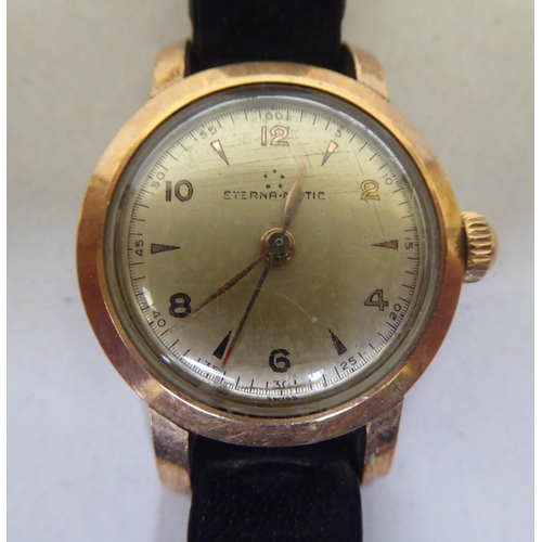 267 - A lady's Eterna-Matic gold plated, stainless steel cased lady's wristwatch, faced by a baton and Ara... 