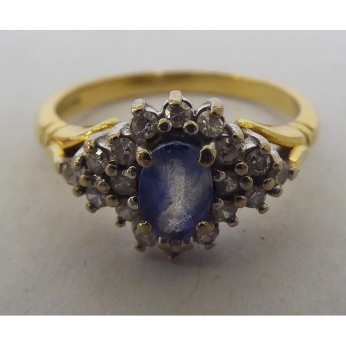 276 - An 18ct bi-coloured gold sapphire and diamond cluster ring