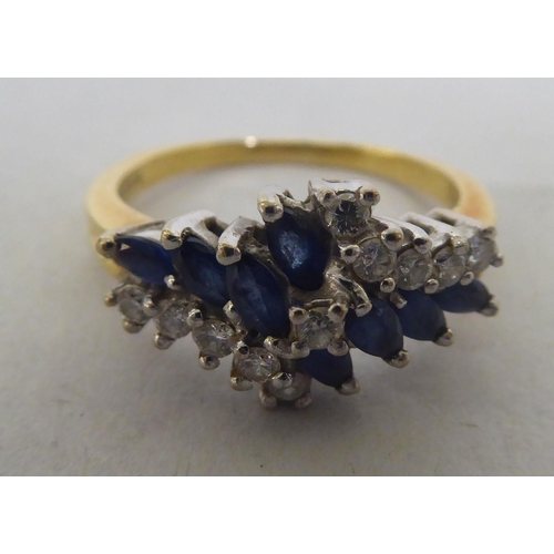 278 - An 18ct bi-coloured gold, sapphire and diamond cluster ring