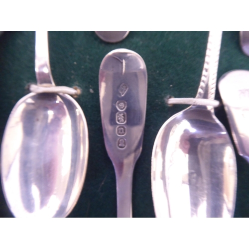 308 - A presentation case with a deep set, glazed oak door, containing silver teaspoons