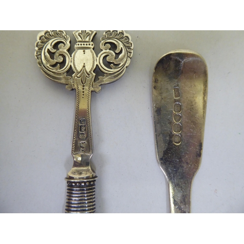 309 - Silver collectables: to include butter knives with loaded handles; a sauce boat and dwarf candlestic... 