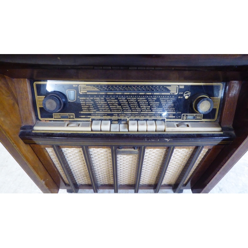 40 - A vintage Aristrona freestanding valve radiogram, in a wood veneered case  34