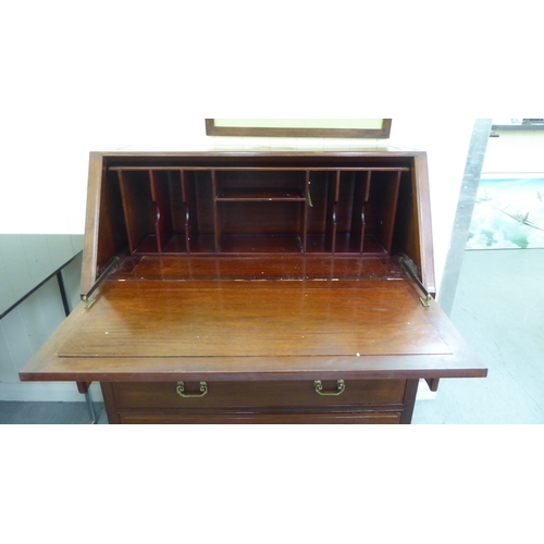 54 - A modern Chinese fruitwood bureau with a fall flap, over two short/two long drawers, raised on block... 