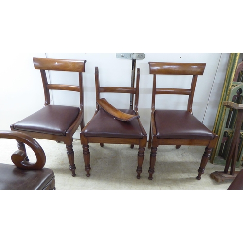 63 - A set of four late Regency mahogany framed, curved bar back dining chairs with upholstered seat pads... 