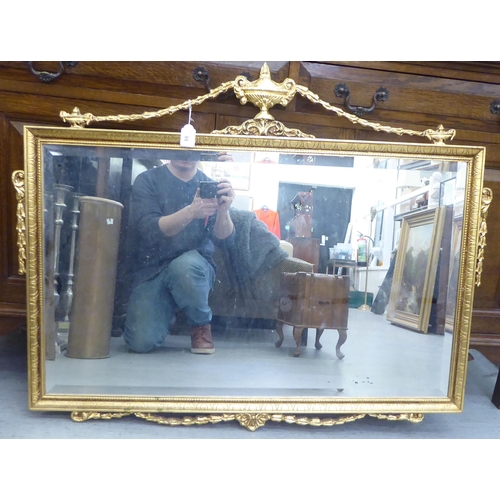 88 - A modern Regency style mirror, the bevelled plate set in an ornately decorated gilt frame  30