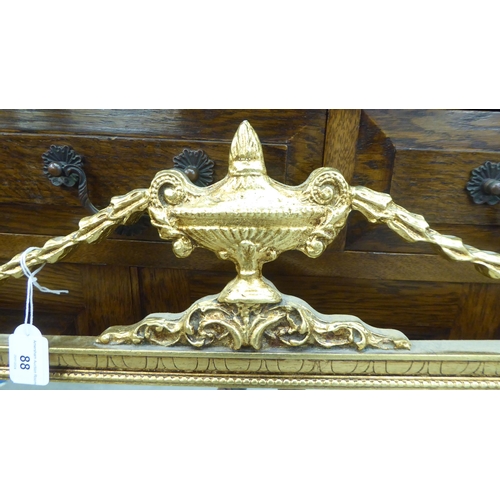 88 - A modern Regency style mirror, the bevelled plate set in an ornately decorated gilt frame  30