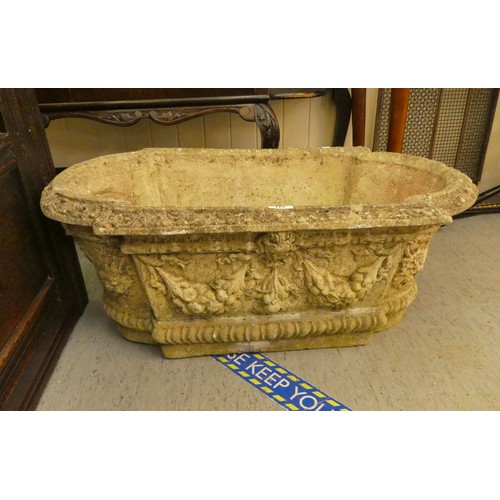 227 - A composition stone garden trough with mask motifs  12