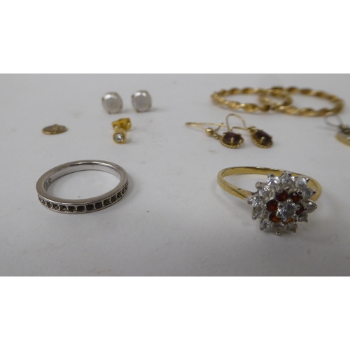 114 - Yellow and gold coloured metal jewellery: to include hoop earrings; a seal pendant; and a claw set c... 