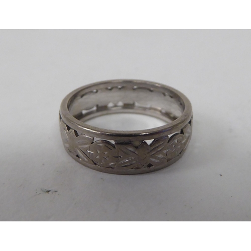 127 - A 1970s 18ct white gold band ring with pierced and engraved decoration