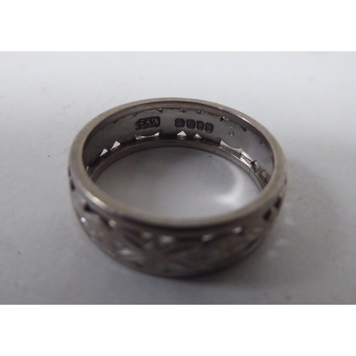 127 - A 1970s 18ct white gold band ring with pierced and engraved decoration