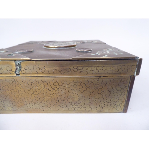 131 - A Chinese brass casket with engraved decoration, mounts, applied medallions and a carved jade tablet... 