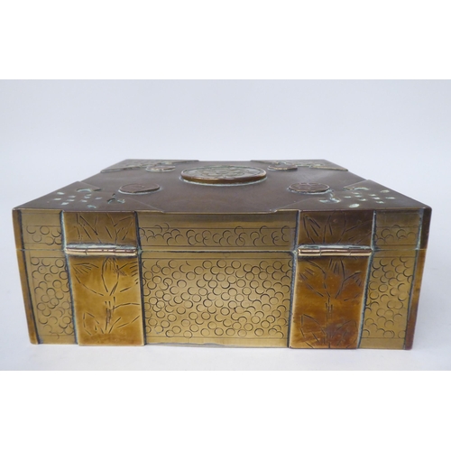 131 - A Chinese brass casket with engraved decoration, mounts, applied medallions and a carved jade tablet... 