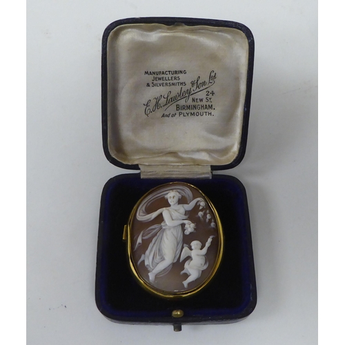 134 - A Victorian yellow metal framed, oval, shell carved cameo brooch, featuring classical dancing figure... 