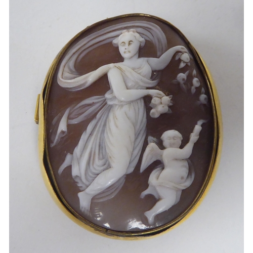 134 - A Victorian yellow metal framed, oval, shell carved cameo brooch, featuring classical dancing figure... 