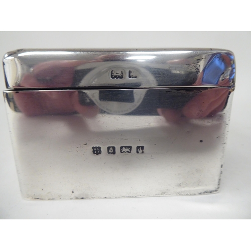 135 - An Edwardian silver cigarette box with straight sides and a hinged lid, enclosing a cedar lined inte... 