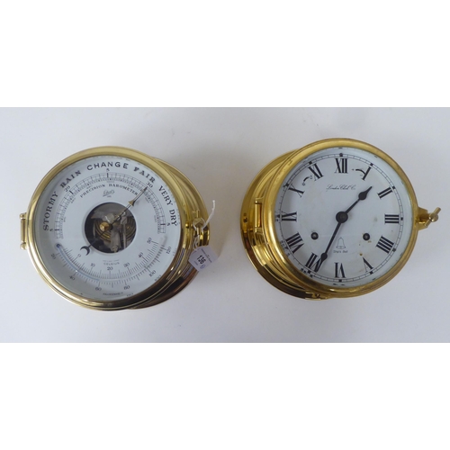 136 - A modern London Clock Co lacquered brass cased bulkhead timepiece; faced by a printed Roman dial; an... 