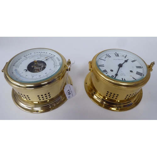 136 - A modern London Clock Co lacquered brass cased bulkhead timepiece; faced by a printed Roman dial; an... 