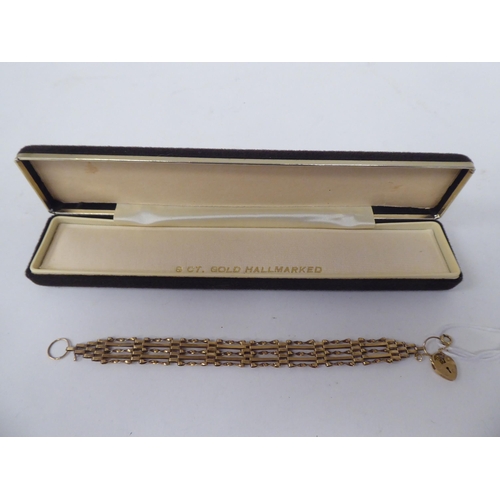 138 - A 9ct gold fancy gate link bracelet, on a padlock clasp and safety chain  boxed