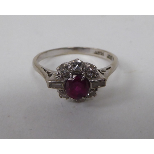 139 - A white metal, claw set ruby and diamond cluster ring