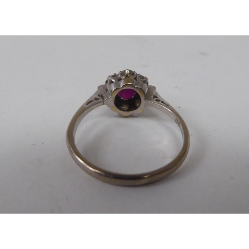 139 - A white metal, claw set ruby and diamond cluster ring