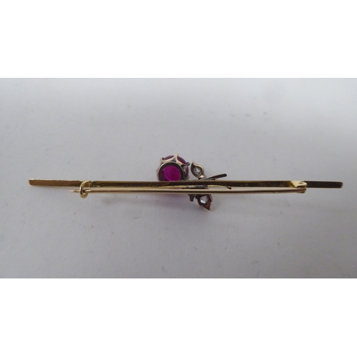 146 - A Victorian yellow metal (probably 15ct gold) bar brooch, claw set with red and white stones