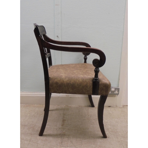 149 - An early 19thC mahogany framed chair with a rope carved bar crest, a triple bar splat back and reede... 