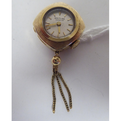 155 - A lady's 1950s Breitling 9ct gold cased lapel/buttonhole watch with a tasselled pendant, faced by a ... 