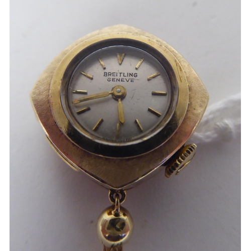 155 - A lady's 1950s Breitling 9ct gold cased lapel/buttonhole watch with a tasselled pendant, faced by a ... 