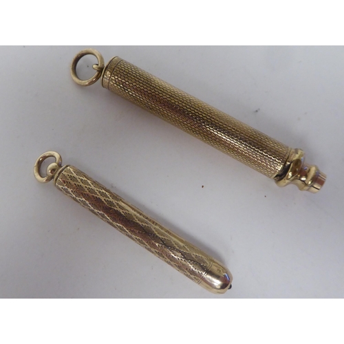 159 - Two similar yellow metal cased propelling pencils, on pendant rings