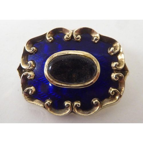 160 - A Victorian (probably 15ct) gold and midnight blue enamel mourning brooch, in a C-scrolled frame