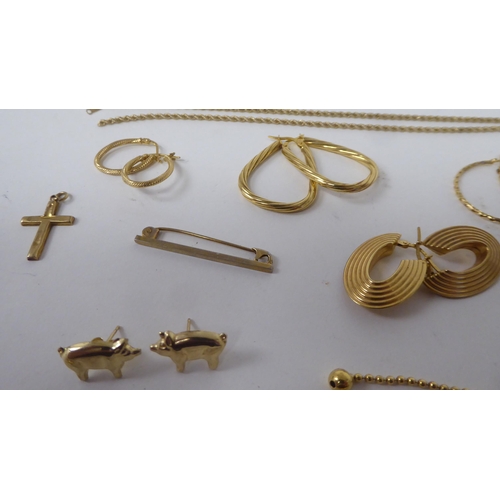 161 - Yellow metal items of personal ornament: to include half hoop earrings; a pendant cross; and a tiepi... 