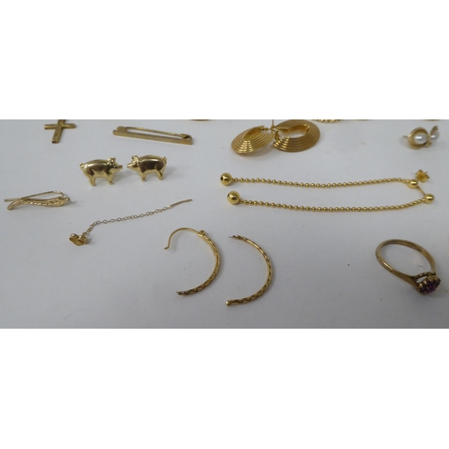 161 - Yellow metal items of personal ornament: to include half hoop earrings; a pendant cross; and a tiepi... 