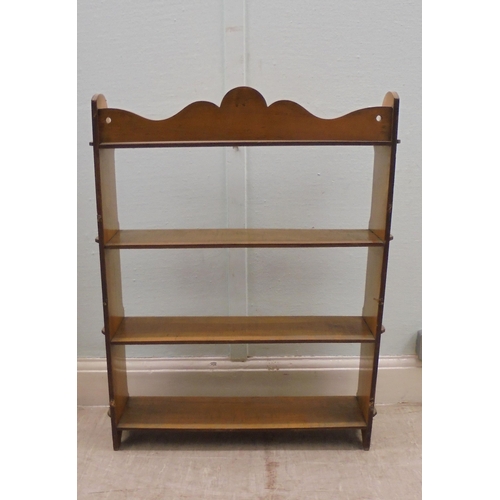 162 - An early 20thC planked satinwood four tier hanging bookcase with pegged ends  34