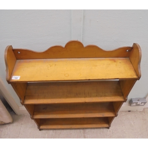 162 - An early 20thC planked satinwood four tier hanging bookcase with pegged ends  34