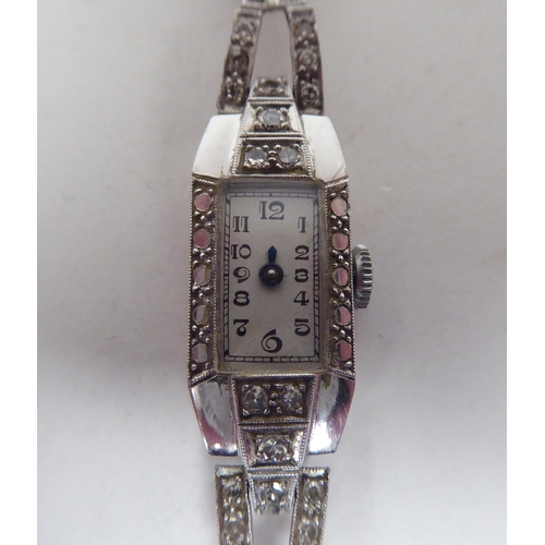 167 - A lady's 1920s diamond encrusted, platinum cased cocktail watch, on a flexible black cord strap, fac... 