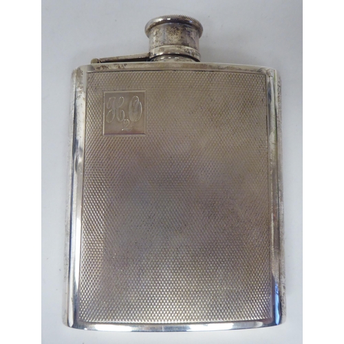 172 - A silver hip flask of curved form with engine turned decoration and a rotating, hinged cap  WRA  Lon... 