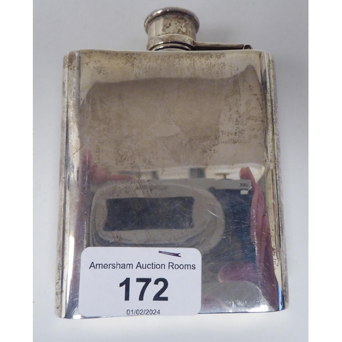 172 - A silver hip flask of curved form with engine turned decoration and a rotating, hinged cap  WRA  Lon... 