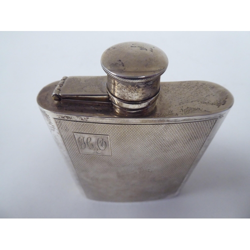 172 - A silver hip flask of curved form with engine turned decoration and a rotating, hinged cap  WRA  Lon... 