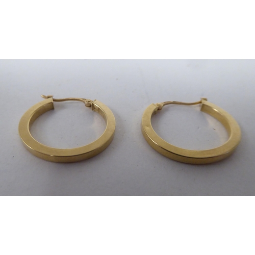 174 - A pair of 18ct gold half-hoop earrings