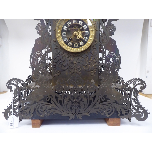 175 - A Continental fretworked brass cased mantel clock, featuring nude term figures, heraldic lions, flor... 