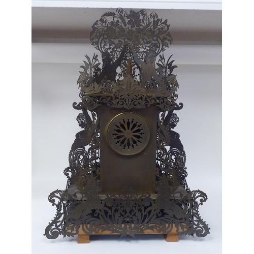 175 - A Continental fretworked brass cased mantel clock, featuring nude term figures, heraldic lions, flor... 