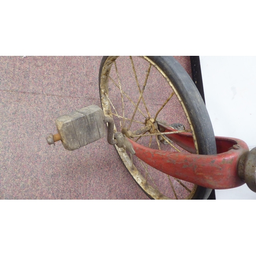 182 - A child's vintage Tri-ang bicycle with a red painted frame and downswept handlebars, the pedals fitt... 