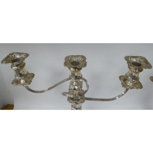 183 - A pair of Georgian style, two-part silver candelabra, each comprising a central socket and two scrol... 