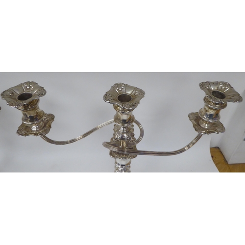 183 - A pair of Georgian style, two-part silver candelabra, each comprising a central socket and two scrol... 